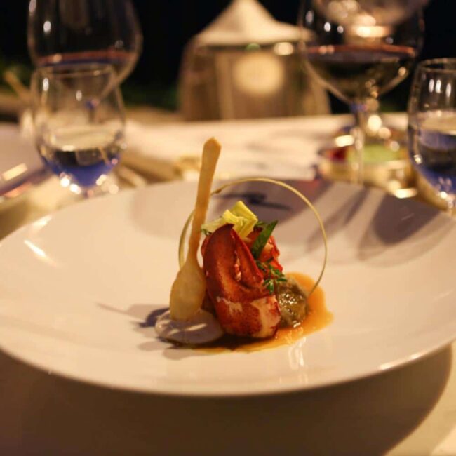 Plated lobster course with wine at a Ravello restaurant