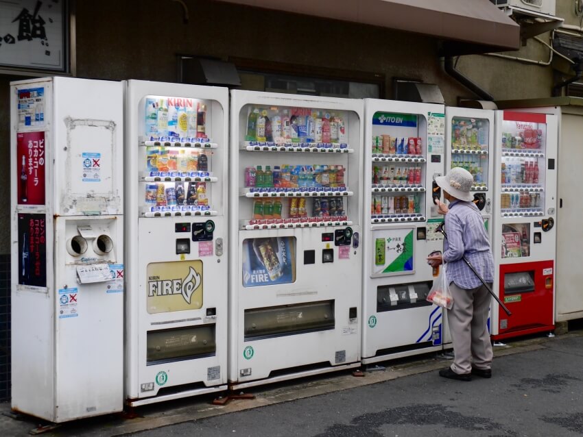 Old Woman Using a Vending Machine