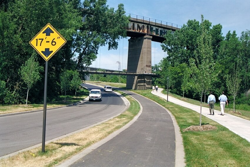 Two People on the Side of the Road and a Skyway