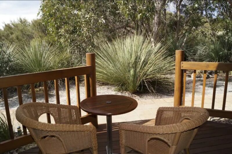 Chairs and a Table on a Balcony