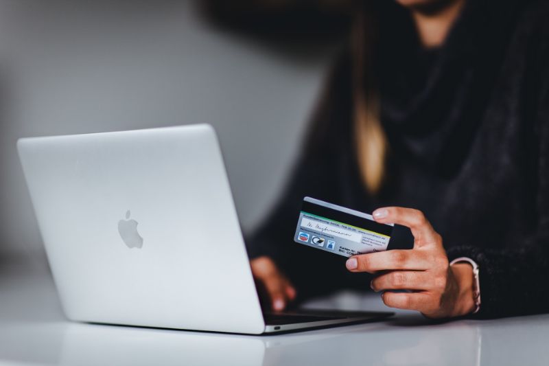 Woman using a credit card for online purchase