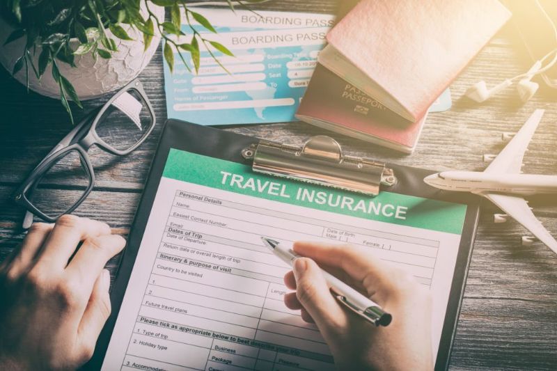 Hand singing a Travel Insurance Form