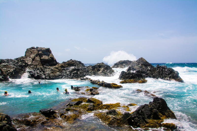 People swimming on the natural pool at Santa Cruz, Aruba