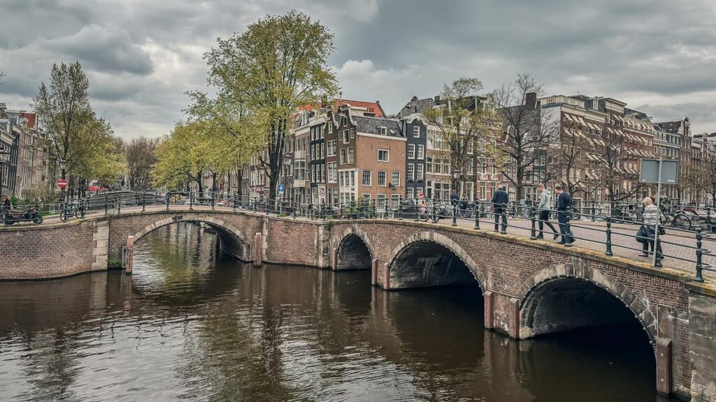 Amsterdam Reguliersgracht canal with iconic Dutch architecture and serene waterways, sRGB color space.