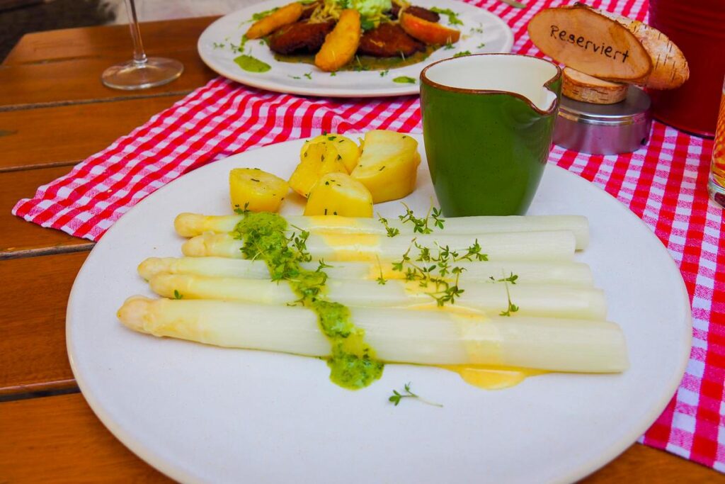 Authentic German White Asparagus (Spargel) with Butter Sauce, Potatoes on White Plate