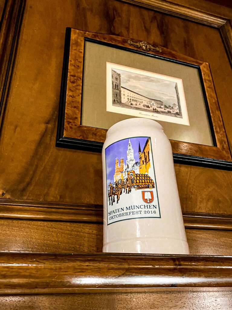 Authentic Spaten München Beer Stein Display in Munich Tavern - Oktoberfest 2016 commemorative ceramic beer stein with Spaten logo and Munich imagery.