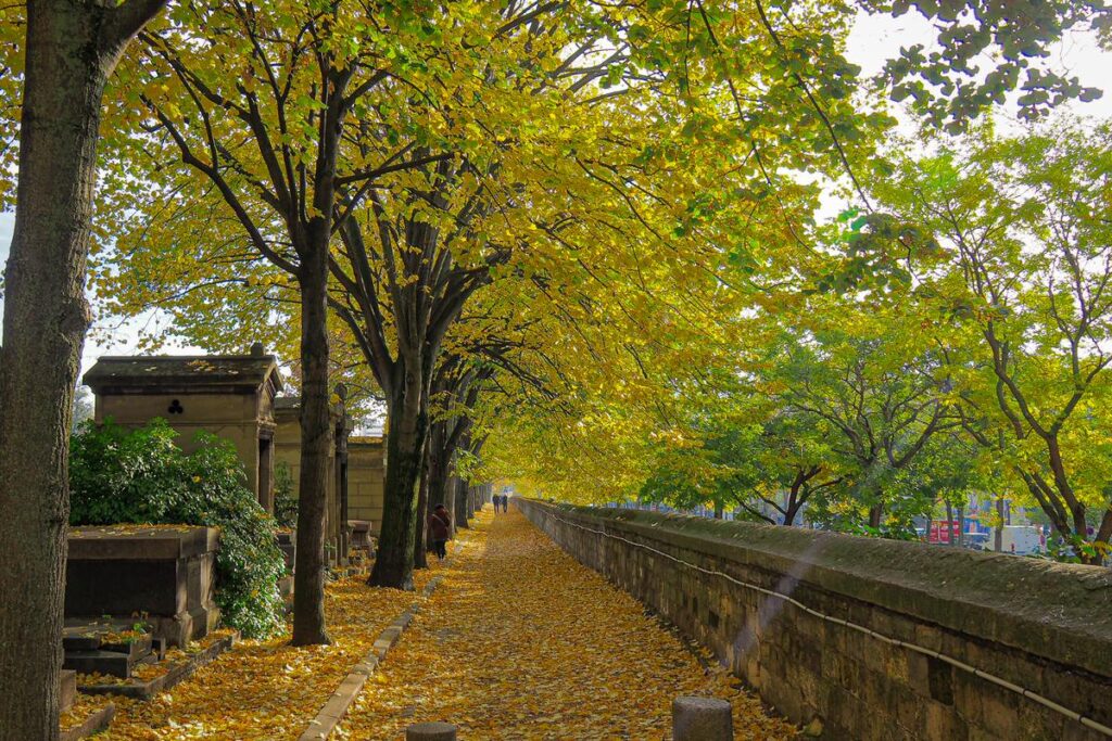 Autumn walk in Père-Lachaise Cemetery Paris with golden leaves and historic tombs