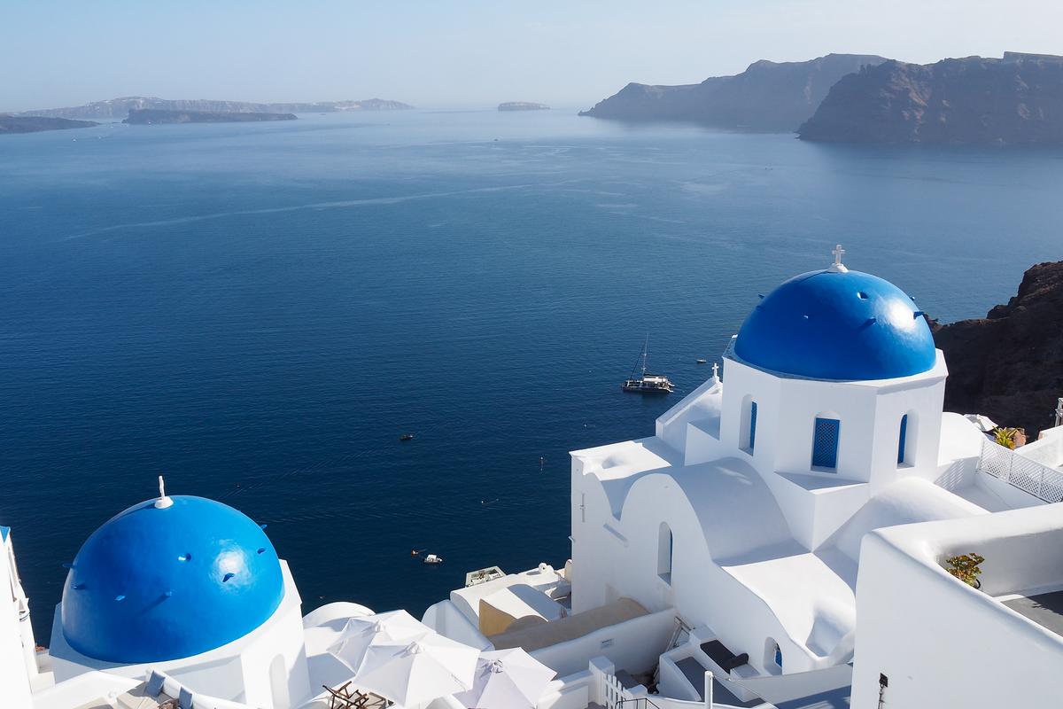 Blue-domed churches in Oia overlooking Santorini's caldera