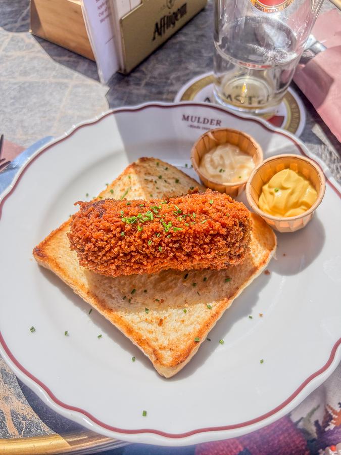 Dutch kroket in Amsterdam street, iconic savory snack, culinary experience in the Netherlands