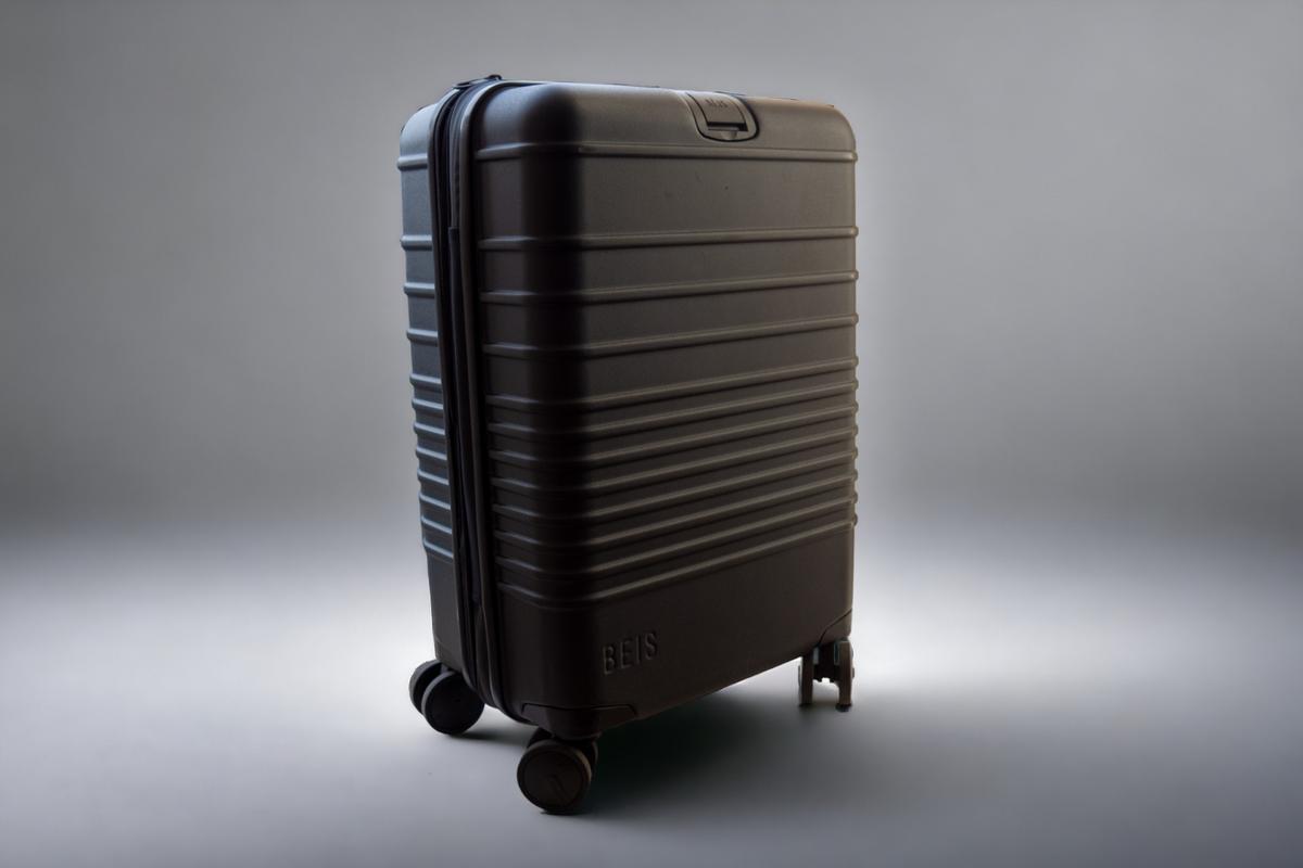 Charcoal Beis carry-on roller suitcase with horizontal lining and brand logo, showcasing elegance and practical features for travelers.