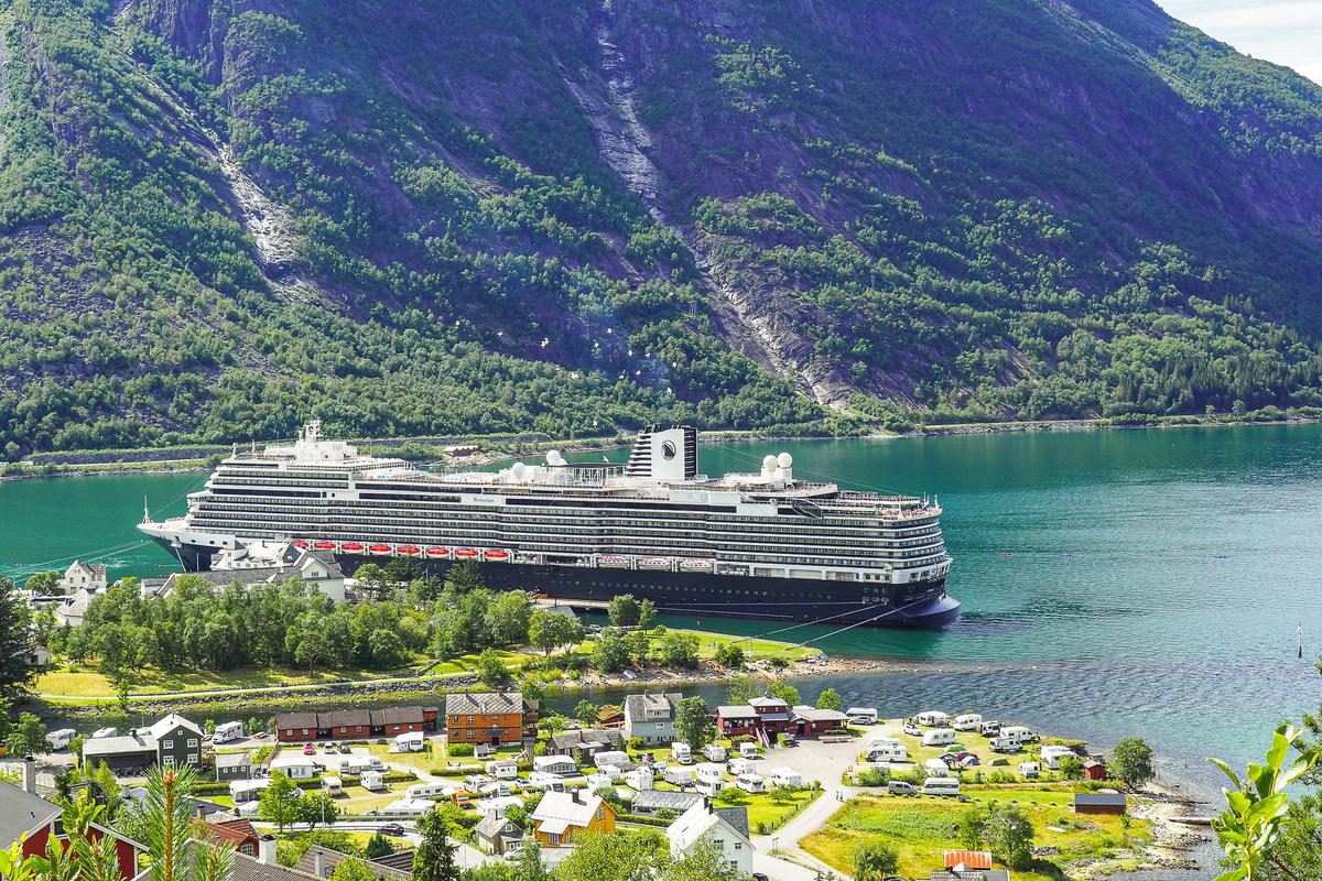 Holland America cruise ship in Eidfjord, Norway, surrounded by mountains and fjord