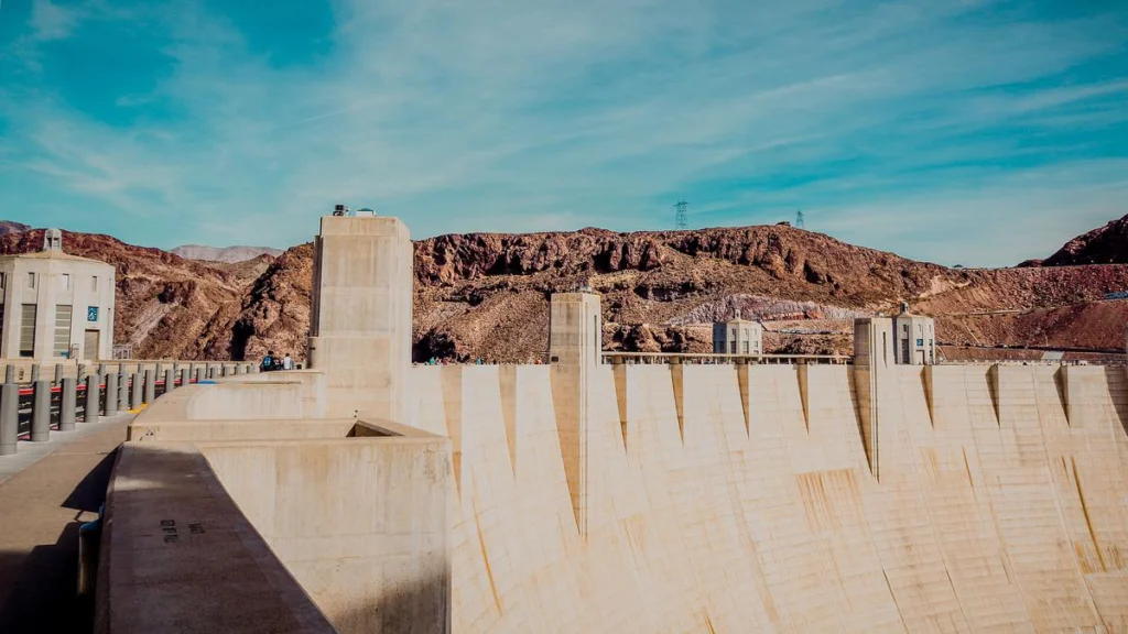 Top section view of Hoover Dam's concrete arch structure against a mountainous backdrop