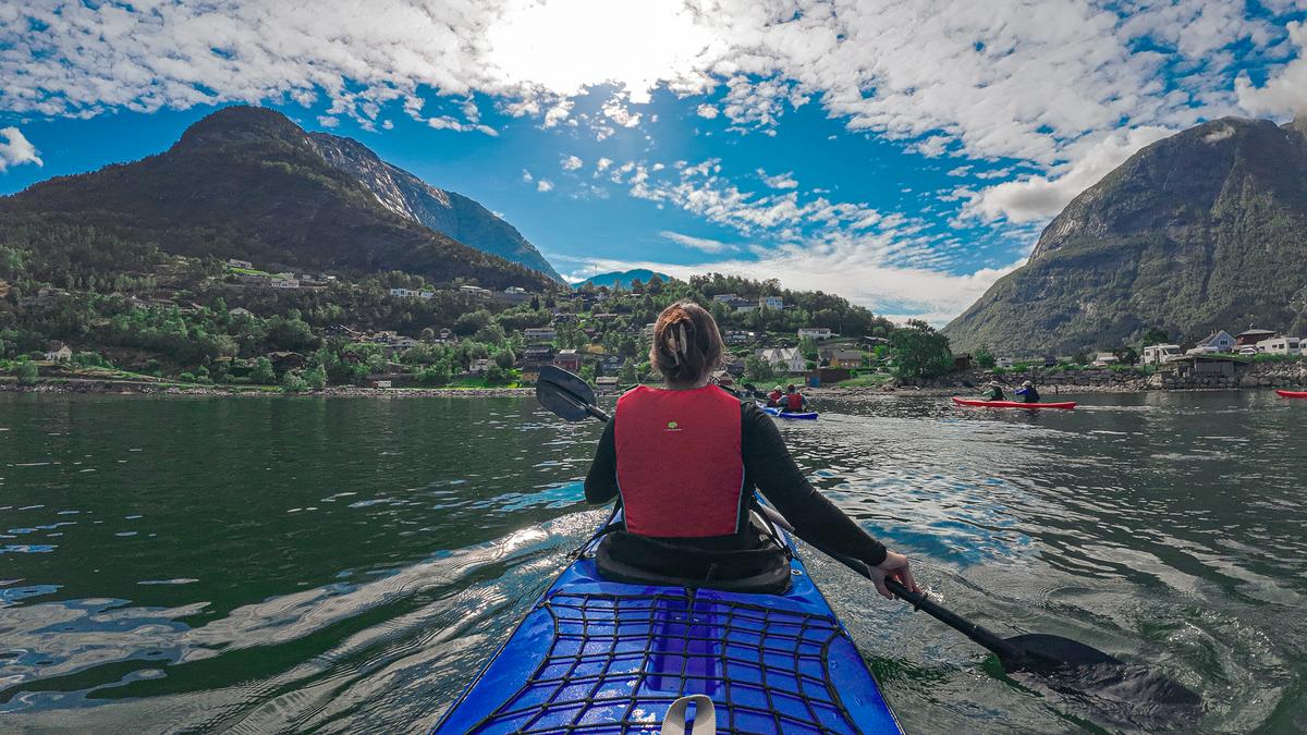 Kayaking in the fjords of Eidfjord, Norway with stunning mountains and serene waters