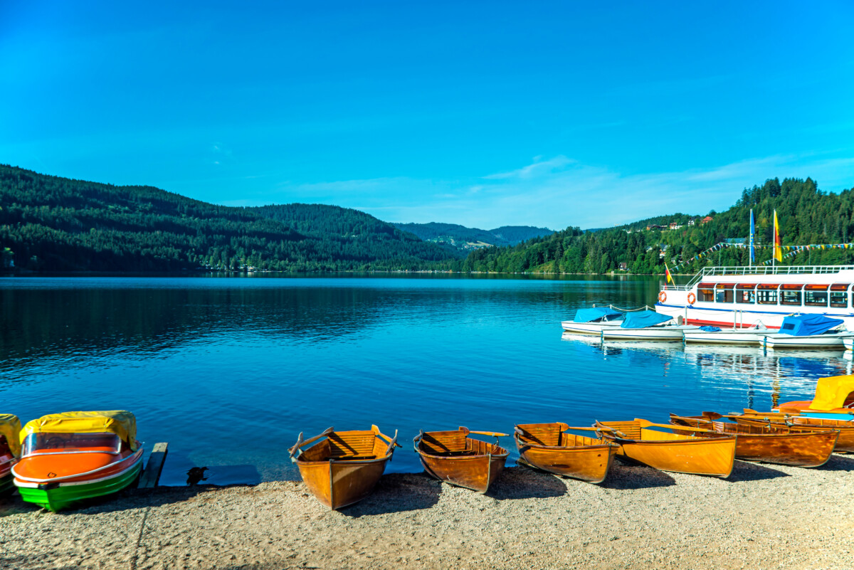 Colorful boats and the scenic view of Lake Titisee in Titisee-Neustadt, Germany