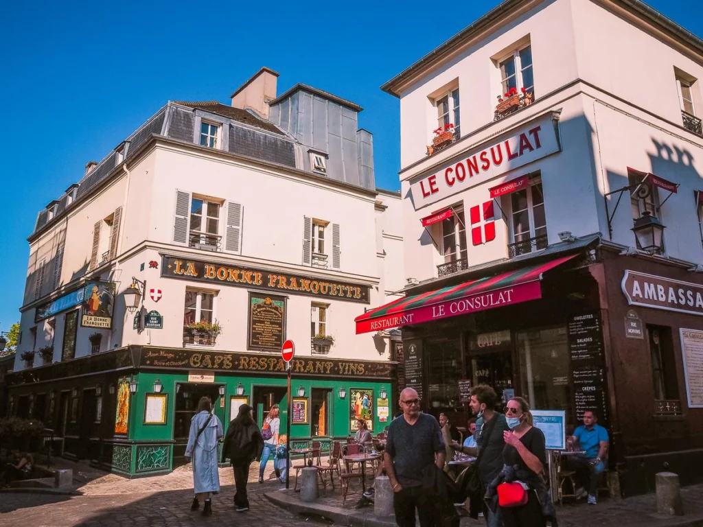 Montmartre's Le Consulat and La Bonne Franquette cafes bustling with Parisian charm