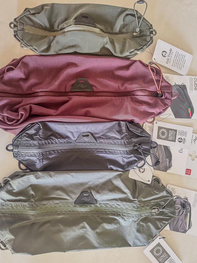 Peak Design mesh and normal packing cubes in various colors for organized travel packing