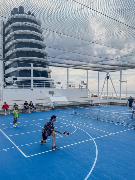 Playing pickleball on Holland America cruise ship deck with ocean views