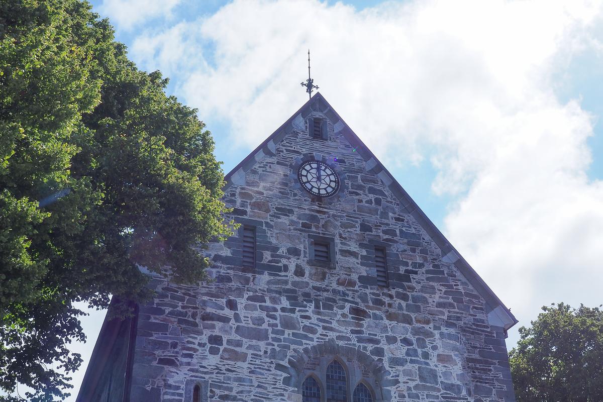 Stavanger Cathedral facade with clock, historic stone architecture in Stavanger, Norway.