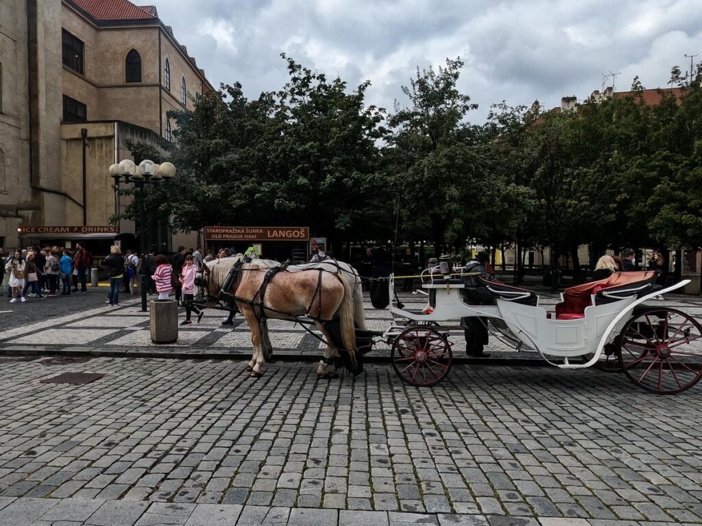 Traditional Horse-Drawn Carriage in Historic Prague Square