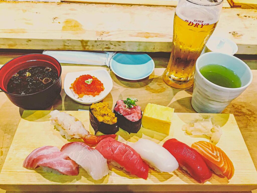 Authentic sushi platter and drinks at Tsukiji Market, Tokyo